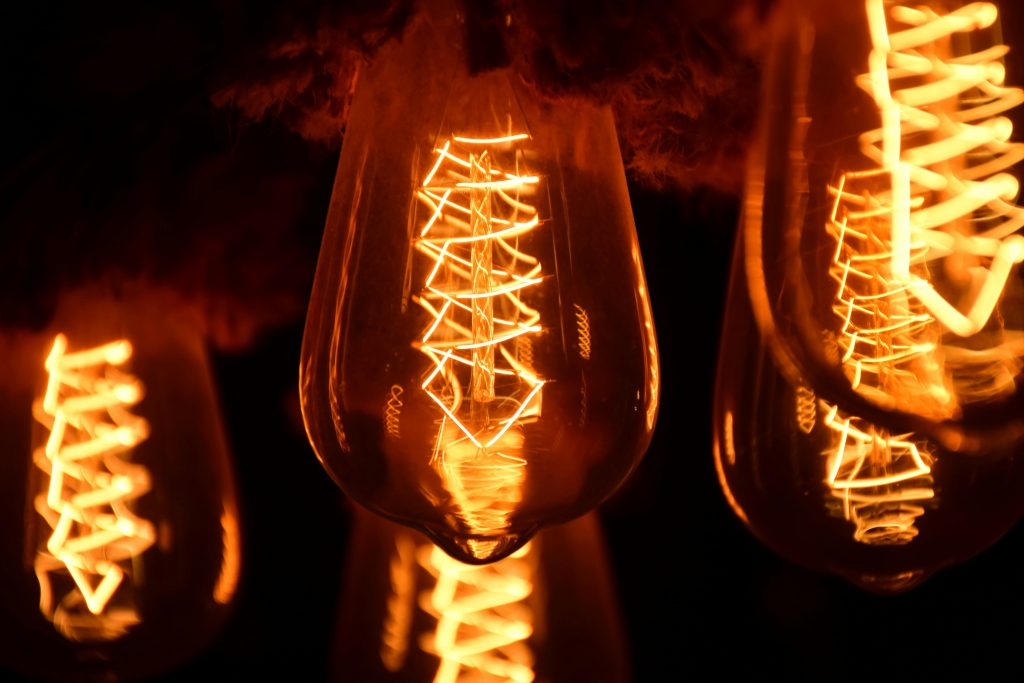 A close-up image of glowing vintage Edison light bulbs showcasing intricate filaments.